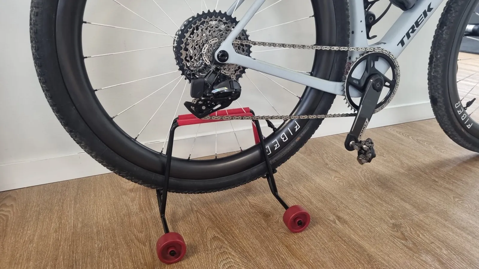 Mountain bike with a wide knobbly tyre held in the same stand.